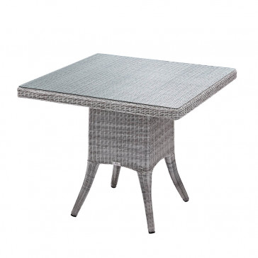 Four seater grey rattan garden table at an angle with white background