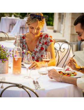 Couple sitting at a polished steel bistro dining set having dinner