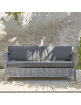 Two-seater rattan couch with UV resistant cushions in French grey on a southern French terrace