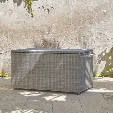 Rattan garden storage box on a southern french terrace pictured at an angle showing handle