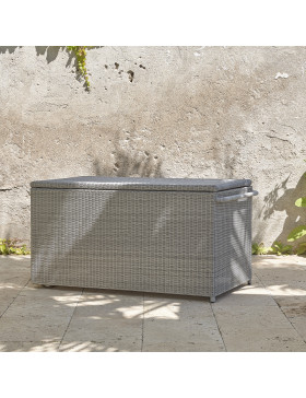 Rattan garden storage box on a southern french terrace pictured at an angle showing handle