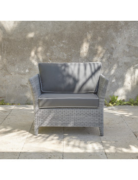 Durable and elegant rattan garden armchair in French grey with UV resistant cushions on a southern French terrace