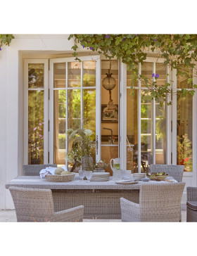 Six seater table and chairs. French Grey rattan. On a French terrace.